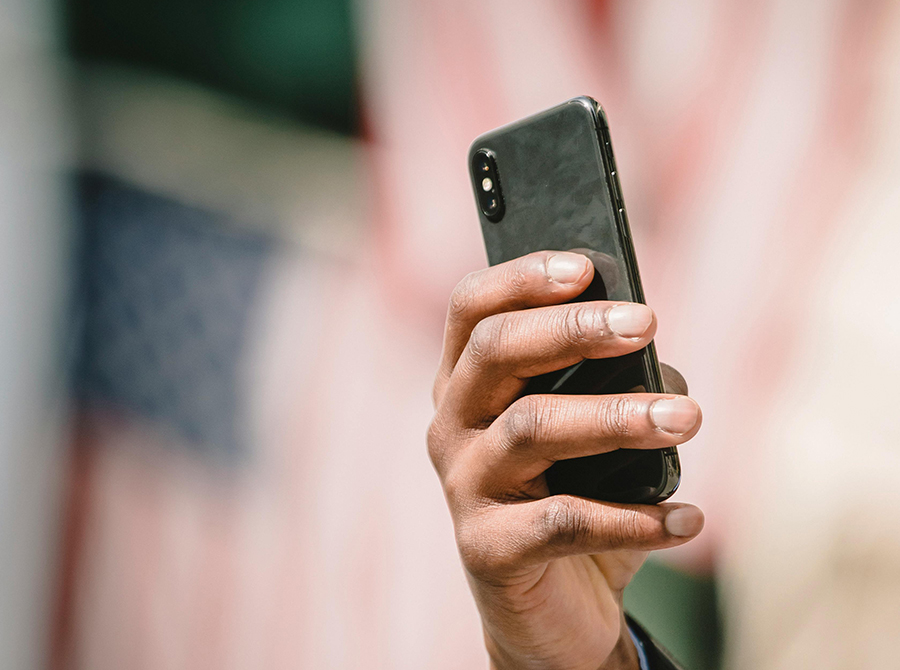 A hand holding a mobile phone